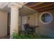 Covered patio offers an outdoor seating area with charming pillars and a round window at 2874 Tori Way, Henderson, NV 89074