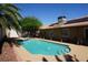 Enjoy a refreshing backyard pool with covered patio and solar panels on house roof at 2874 Tori Way, Henderson, NV 89074