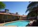 Backyard pool with covered patio, solar panels, and desert landscaping at 2874 Tori Way, Henderson, NV 89074