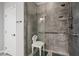 Accessible bathroom featuring a walk-in shower with a built-in seat and safety bars at 3708 Fuselier Dr, North Las Vegas, NV 89032
