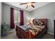 Cozy bedroom with a ceiling fan, large window, and traditional furniture at 3708 Fuselier Dr, North Las Vegas, NV 89032