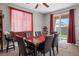 Charming dining room with a sliding glass door, seating for six, and a view to the backyard at 3708 Fuselier Dr, North Las Vegas, NV 89032