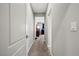 Hallway featuring neutral walls and carpeting, leading to bedrooms with plenty of natural light at 3708 Fuselier Dr, North Las Vegas, NV 89032