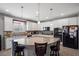 Bright kitchen features white cabinets, a spacious island with granite counters, and stainless steel appliances at 3708 Fuselier Dr, North Las Vegas, NV 89032