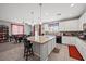 Open kitchen design features white cabinets, an island with pendant lighting, and a dining area nearby at 3708 Fuselier Dr, North Las Vegas, NV 89032