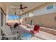 Relaxing covered patio with multiple ceiling fans, seating, and a decorative fountain at 387 Larksong Ave, Henderson, NV 89011