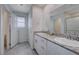 Bright bathroom with double sinks, granite countertop, and white cabinets at 387 Larksong Ave, Henderson, NV 89011