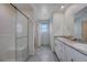 Modern bathroom with double vanity, granite countertop and walk-in shower at 387 Larksong Ave, Henderson, NV 89011