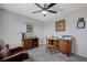 Relaxing bedroom area with a fan, natural light, desk, and chair at 387 Larksong Ave, Henderson, NV 89011