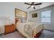 Comfortable bedroom features a ceiling fan, soft lighting, and art, creating a serene and inviting space at 387 Larksong Ave, Henderson, NV 89011