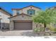 Charming two-story home featuring a stone facade, two-car garage and manicured landscaping at 387 Larksong Ave, Henderson, NV 89011