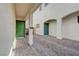 Side-view of a modern home with a gravel driveway and a green front door at 387 Larksong Ave, Henderson, NV 89011