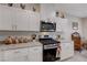 Bright kitchen featuring stainless steel appliances, granite countertops, and sleek white cabinets at 387 Larksong Ave, Henderson, NV 89011