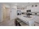 Modern kitchen featuring stainless steel appliances, white cabinetry, and a granite-topped island with bar stool seating at 387 Larksong Ave, Henderson, NV 89011