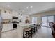 Modern kitchen with white cabinets, granite countertops, and a breakfast bar at 387 Larksong Ave, Henderson, NV 89011