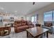 Spacious living room with a cozy seating area and adjacent dining space at 387 Larksong Ave, Henderson, NV 89011