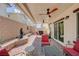 Well-designed covered patio with a ceiling fan, ample seating, and a peaceful water feature at 387 Larksong Ave, Henderson, NV 89011