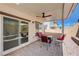 Covered patio area with outdoor seating and fan, perfect for relaxing at 387 Larksong Ave, Henderson, NV 89011