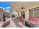 Inviting covered patio with ceiling fans, a built-in water feature, and plenty of seating at 387 Larksong Ave, Henderson, NV 89011