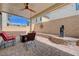 Cozy covered patio features a ceiling fan, a stylish water feature, and ample seating at 387 Larksong Ave, Henderson, NV 89011