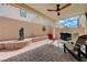 Covered patio with a ceiling fan, string lights, and a beautiful water feature at 387 Larksong Ave, Henderson, NV 89011