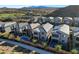 Spacious homes with pools, solar panels, desert landscaping, and mountain views from an aerial perspective at 40 Strada Moscato, Henderson, NV 89011
