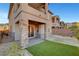 Attractive backyard with a covered patio, brick pillars, artificial grass, and sliding glass door access at 40 Strada Moscato, Henderson, NV 89011