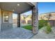 Inviting backyard with a covered patio, brick pillars, artificial grass, and low-maintenance landscaping at 40 Strada Moscato, Henderson, NV 89011