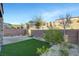 Relaxing backyard with artificial grass, desert landscaping, brick walls, and hillside views at 40 Strada Moscato, Henderson, NV 89011