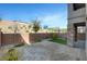 Private backyard features desert landscaping and stone columns on covered patio at 40 Strada Moscato, Henderson, NV 89011