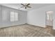 Bright bedroom with neutral carpet, ceiling fan, and an ensuite bathroom at 40 Strada Moscato, Henderson, NV 89011