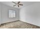 Bright bedroom with ceiling fan, large window, and neutral carpet at 40 Strada Moscato, Henderson, NV 89011