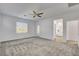 Expansive bedroom featuring neutral carpet, ceiling fan, and a door to the exterior at 40 Strada Moscato, Henderson, NV 89011