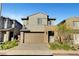 Charming two-story home with a two-car garage and stone accents, enhanced by lush landscaping at 40 Strada Moscato, Henderson, NV 89011