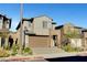 Two-story home boasts a two-car garage and modern architectural design, complemented by desert landscaping at 40 Strada Moscato, Henderson, NV 89011