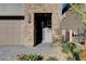 Inviting front entryway with stone columns and pavers, providing a welcoming approach to the home at 40 Strada Moscato, Henderson, NV 89011