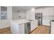 Open concept kitchen with stainless steel appliances and quartz countertops at 40 Strada Moscato, Henderson, NV 89011