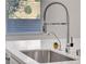 Kitchen sink with quartz countertops, stainless steel faucet, and filtered water faucet at 40 Strada Moscato, Henderson, NV 89011