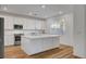 Bright kitchen with stainless steel appliances, a large island and hard wood floors at 40 Strada Moscato, Henderson, NV 89011