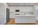 Bright kitchen featuring stainless steel appliances and a large island with quartz countertops at 40 Strada Moscato, Henderson, NV 89011