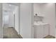 A laundry room with white washer and dryer with overhead shelf at 40 Strada Moscato, Henderson, NV 89011