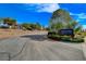 A road leads to Lake Las Vegas Sports Club, with trees and landscaping on a sunny day at 40 Strada Moscato, Henderson, NV 89011