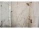 The frameless shower features beautiful marble-style tile and modern gold fixtures at 4065 Genoa Dr, Las Vegas, NV 89141