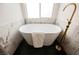 A standalone tub is accented by black tile floors and a gold faucet at 4065 Genoa Dr, Las Vegas, NV 89141