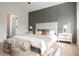 Bright bedroom featuring a decorative accent wall, upholstered headboard and stylish patterned ottomans at 4065 Genoa Dr, Las Vegas, NV 89141