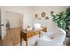 Bright office with a wooden desk, white chair, decorative wall hangings, and wood-look floors at 4065 Genoa Dr, Las Vegas, NV 89141