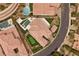 Aerial view showcases the home's backyard oasis with pool, putting green, and lush landscaping at 4220 San Alivia Ct, Las Vegas, NV 89141