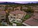 Expansive backyard view of the home with a swimming pool and putting green, great for entertaining at 4220 San Alivia Ct, Las Vegas, NV 89141
