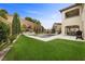 An outdoor oasis featuring a pool, manicured lawn, tasteful landscaping, and ample seating areas at 4220 San Alivia Ct, Las Vegas, NV 89141