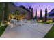 Backyard patio with modern outdoor furniture, manicured landscaping, and a privacy wall at 4220 San Alivia Ct, Las Vegas, NV 89141